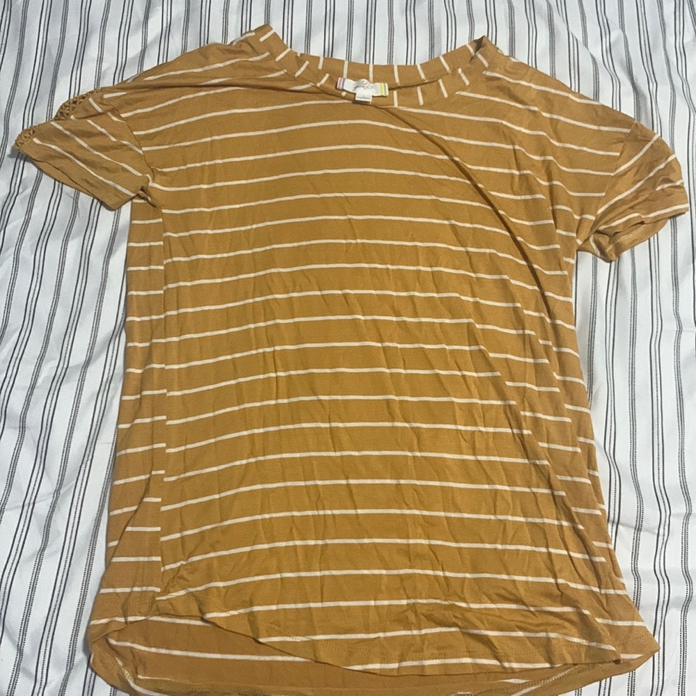 A orange loose shirt with white stripes and with design on shoulders size:L